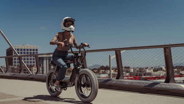 Helmeted rider on a paved path